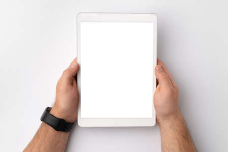 Digital tablet computer close up, man using tablet with hands