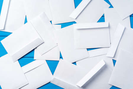 Stack of envelopes on working desk top view. Business mail