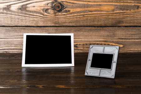 Blank photo frame on brown wooden backgroundの写真素材