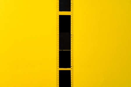 Old vintage film for a camera on yellow backgroundの写真素材
