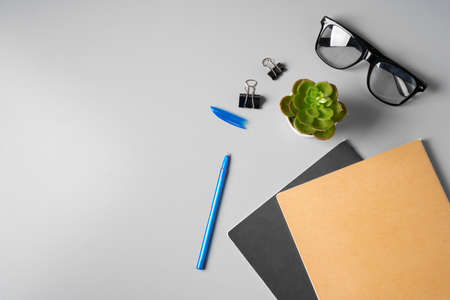Office desk with notepad, glasses and supplies