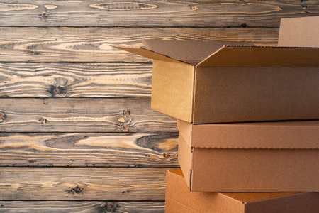 Pile of cardboard boxes on wooden backgroundの写真素材