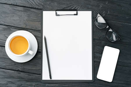 Blank paper on clipboard with space on dark gray background