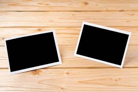 Blank photo frames for your photos on wooden backgroundの写真素材