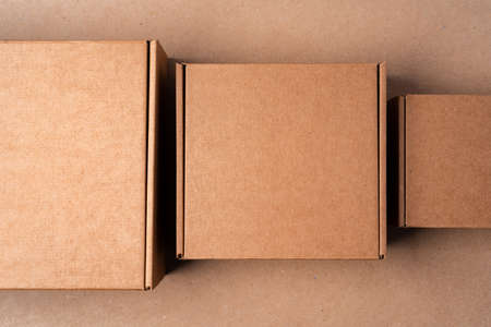 Cardboard box on beige background in studioの写真素材