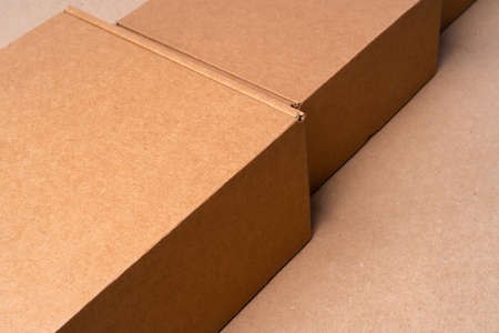 Cardboard box on beige background in studioの写真素材