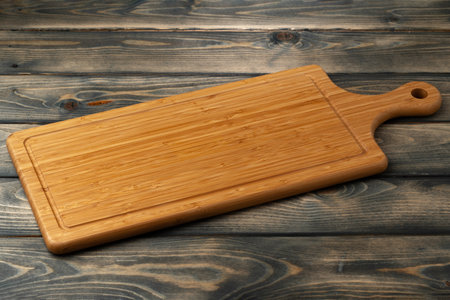 Wooden board for food on wooden backgroundの写真素材