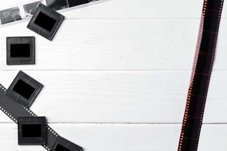 Old vintage film, slides and photos on white wooden backgroundの写真素材