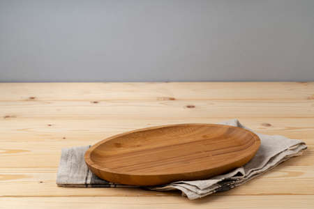 Cutting board with cotton napkin on wooden table