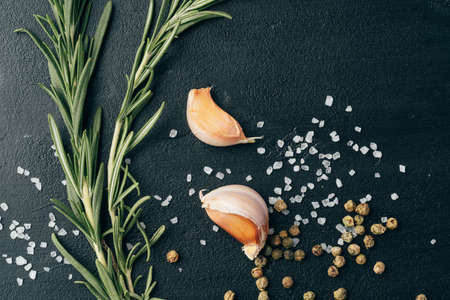 Salt and spices scattered on black backgroundの写真素材