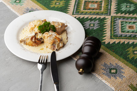 Chicken stewed in a creamy sauce on white plate
