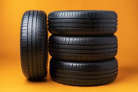 Car tires isolated on yellow background, close up