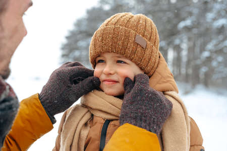 Father and son playing in the park on winter dayの写真素材