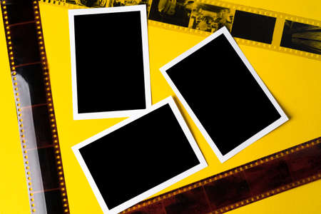 Old vintage film for a camera on yellow background