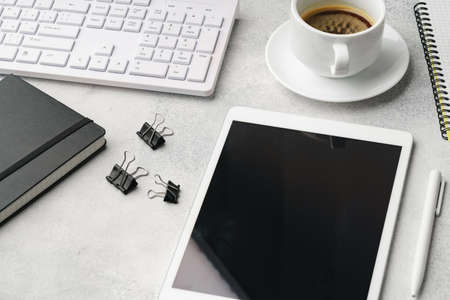 Digital tablet with empty screen on table with business accessories