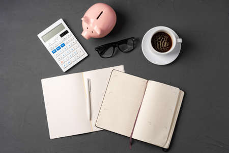 Office desk with notepad, glasses and suppliesの写真素材