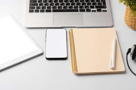 Minimalistic white workplace with keyboard and notebookの写真素材