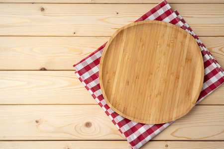 Cutting board with cotton napkin on wooden tableの写真素材