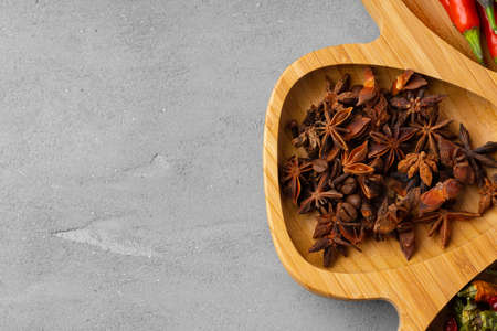 Various spices and herbs on gray background
