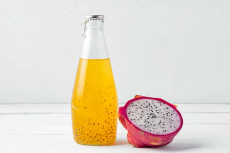 Glass bottle of dragon fruit drink on white backgroundの写真素材
