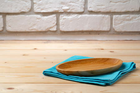 Cutting board with cotton napkin on wooden tableの写真素材
