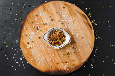 Bowl with spice on wooden board top viewの写真素材