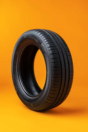 Car tires isolated on yellow background, close up