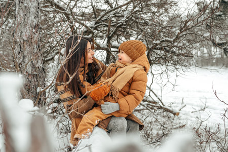Woman with a little son on a winter hike in the snowy forestの写真素材