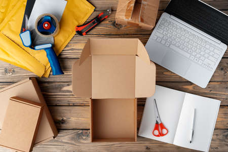 Packing products for delivery on wooden table, top view