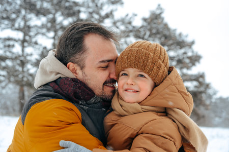 Father and son playing in the park on winter dayの写真素材
