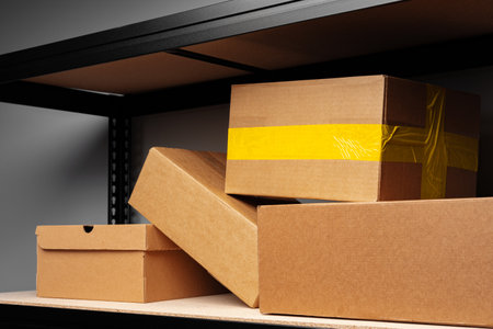 Warehouse shelves with small paper boxes, close up