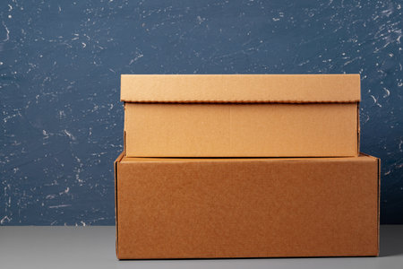 Group of cardboard boxes against blue background