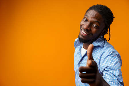 Young african american man wearing casual clothes pointing to you