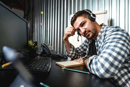 Customer service support operator man with headphones and microphone talking to client in call...