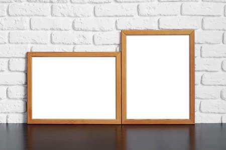 Blank picture frame against brick wall with copy spaceの写真素材