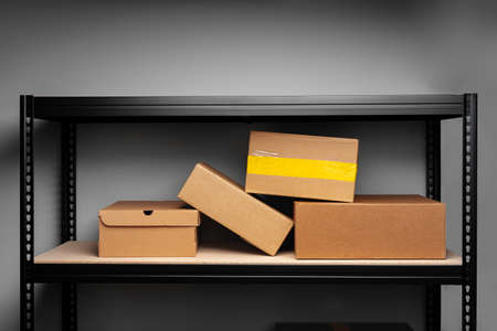 Rack shelves with paper boxes in warehouse.
