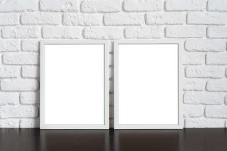Blank picture frame against brick wall with copy space