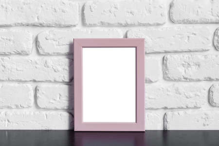 Photo frame with copy space against white brick wall