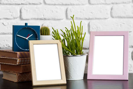 Books with picture frame on wooden table