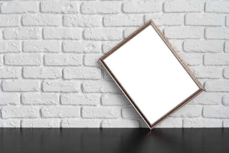 Blank picture frame against brick wall with copy spaceの写真素材
