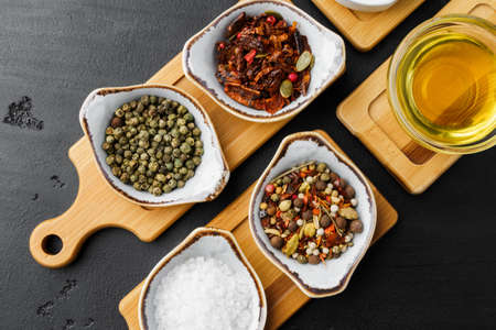 Oil, herbs and spices on wooden backgroundの写真素材