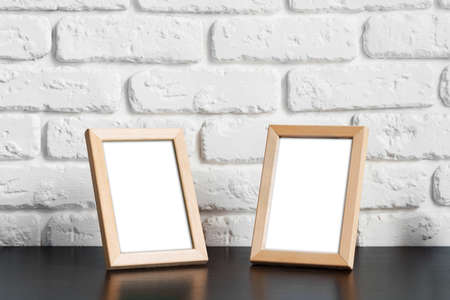 Photo frame with copy space against white brick wallの写真素材