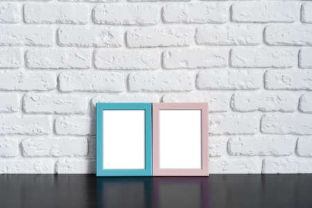 Photo frame with copy space against white brick wallの写真素材