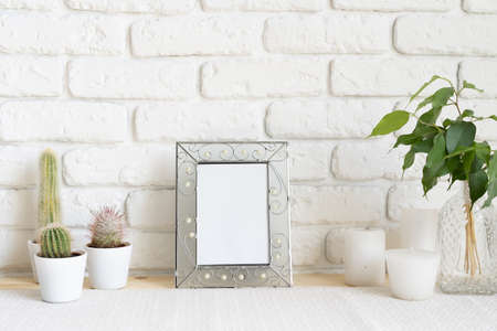 Square wooden photo frame and cactus plants on the table
