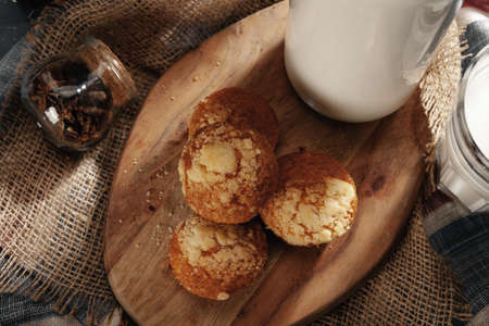 Glass of milk and cookies on tableの写真素材