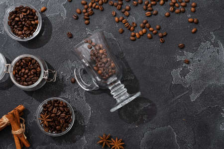 Coffee beans, cinnamon sticks and star anise on dark background top viewの写真素材