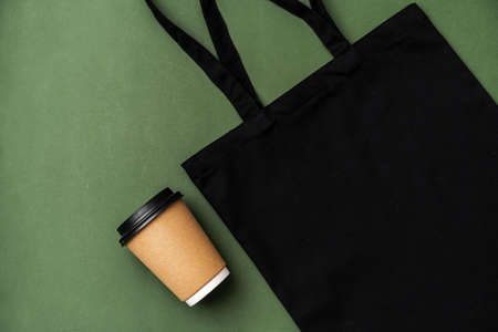Textile shopping bag and coffee cup flat lay