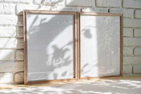 Photo frames on floor over white brick wall