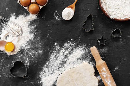 Preparation for baking. Eggs and flour on black background