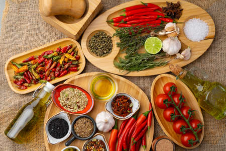 Close up of wooden board with spices, herbs and cooking ingredients
